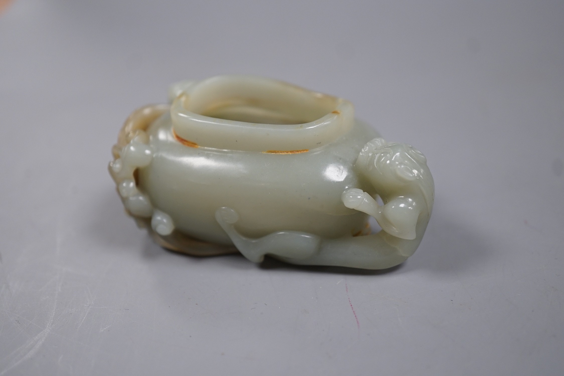 A Chinese celadon jade brushwasher, dragons